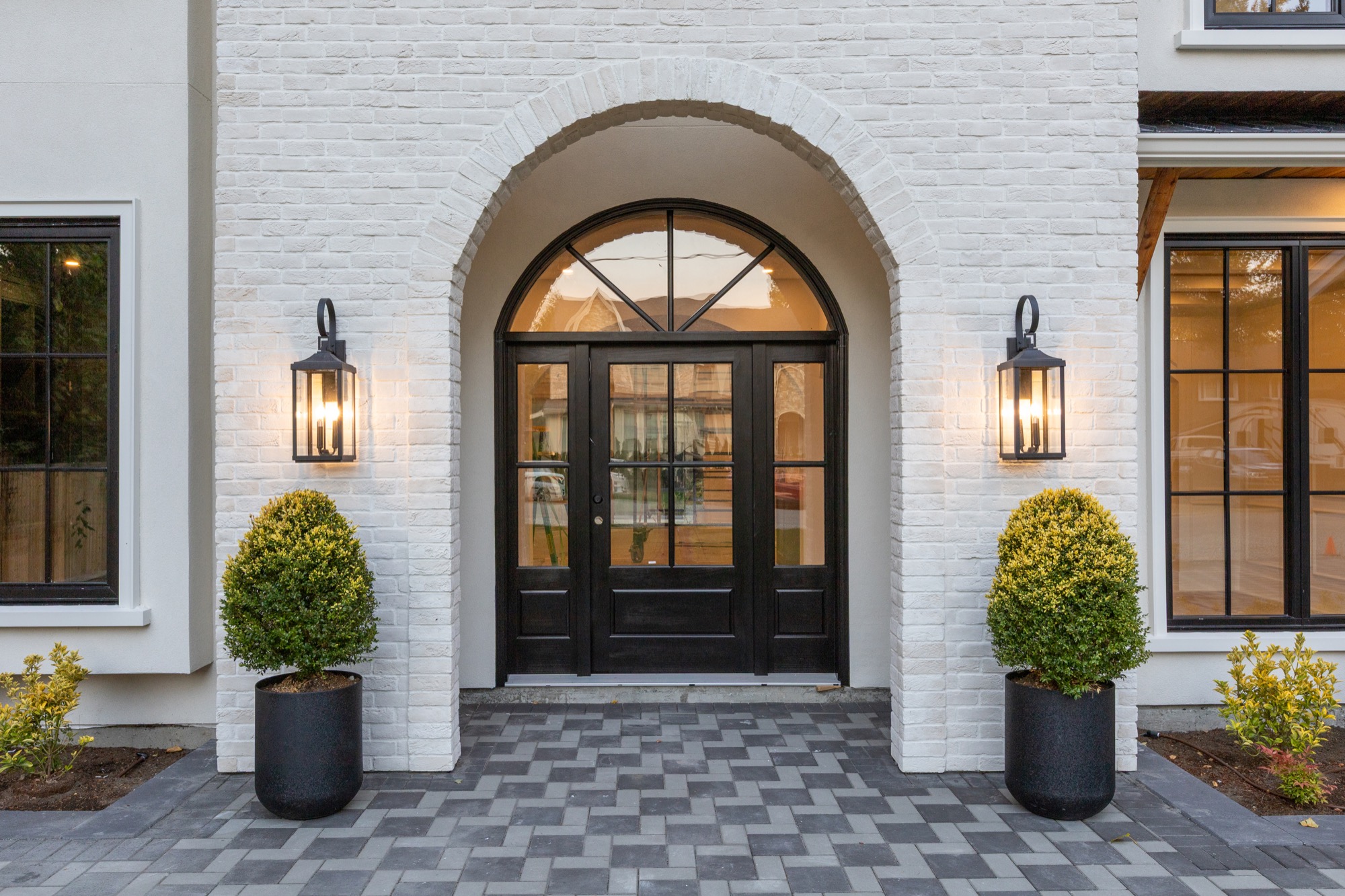 Arched front door with lanterns